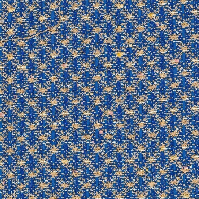 Tweed bleu moyen et beige avec fibres métalliques apportant un éclat discret.