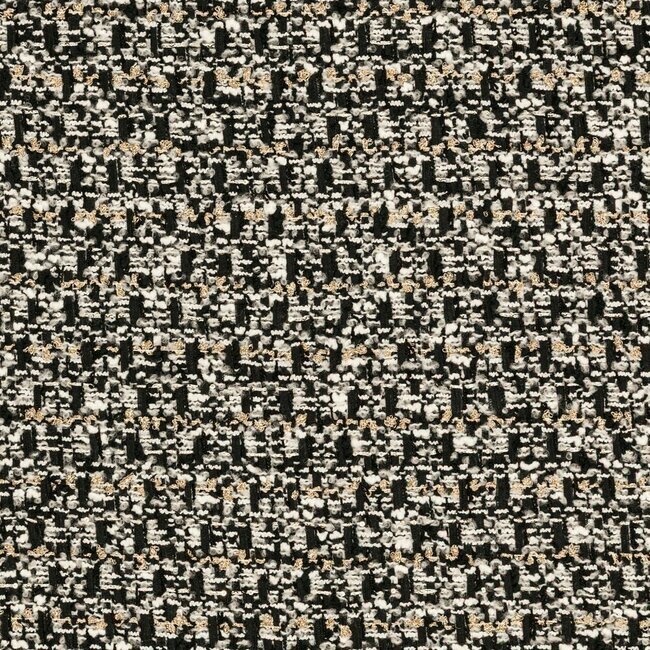 Tweed contrasté noir et blanc avec tissage graphique et reflets métallisés discrets.
