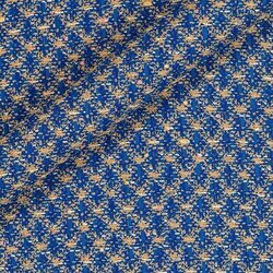 Tweed bleu moyen et beige avec fibres métalliques apportant un éclat discret.