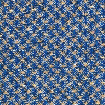 Tweed bleu moyen et beige avec fibres métalliques apportant un éclat discret.